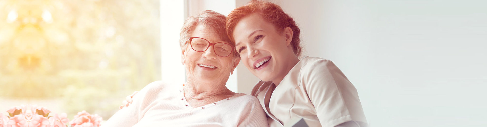 happy senior woman and caretaker